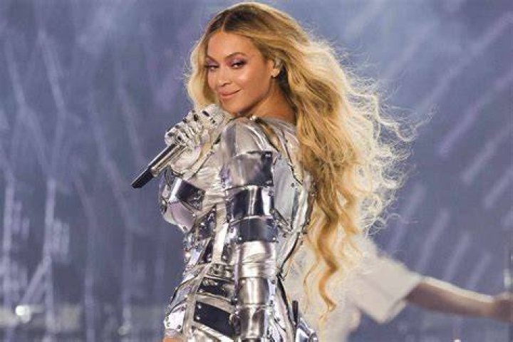 Beyonce performs onstage in silver bejeweled look