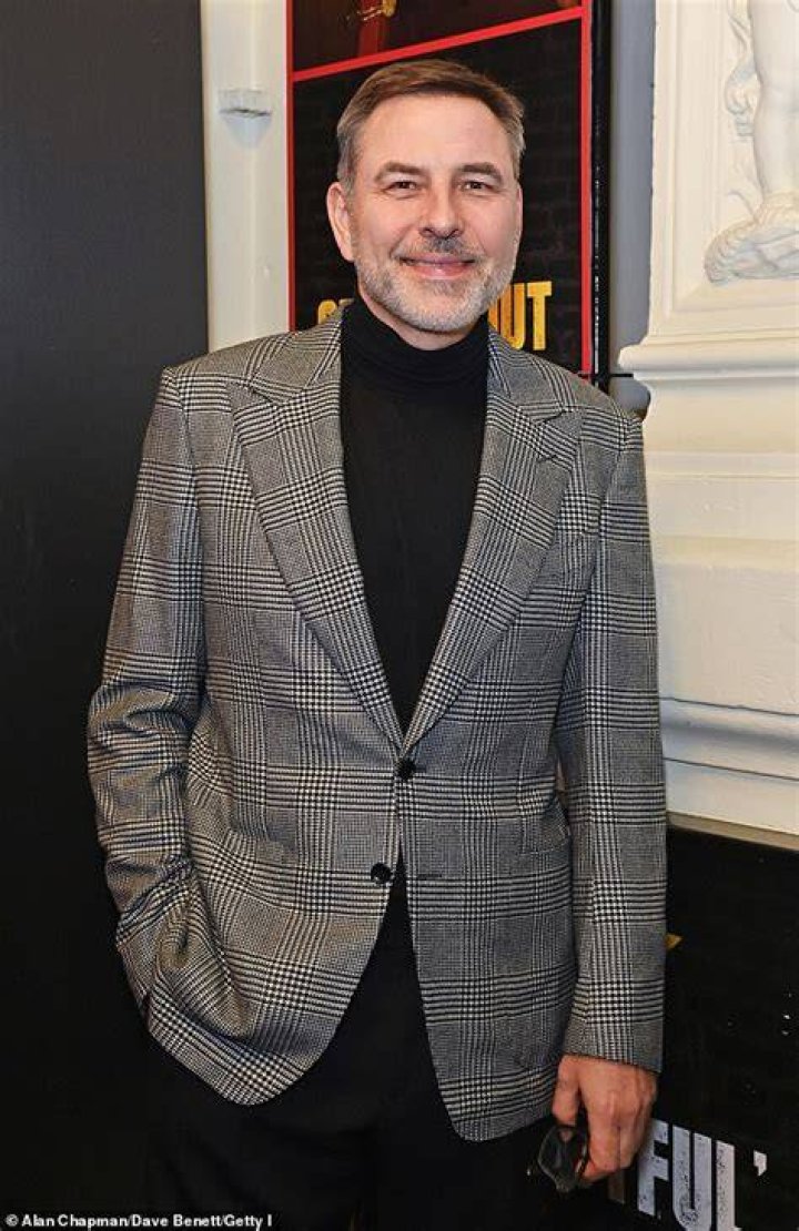 David Walliams in a grey suit and Keeley Hazell in a red dress 