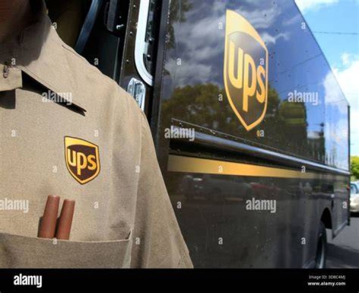FILE - United Parcel Service driver Hudson de Almeida steers through a neighborhood while delivering packages, Friday, June 30, 2023, in Haverhill, Mass. UPS has reached a contract agreement with its 340,000-person strong union Tuesday, July 25, averting a strike that had the potential to disrupt logistics nationwide for businesses and households alike. (AP Photo/Charles Krupa, File)
