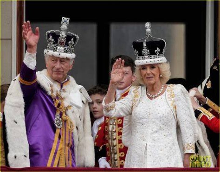 King Charles and Camilla wave on the balcony 