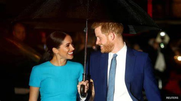 meghan markle and prince harry dance at their wedding, with meghan wearing a backless dress
