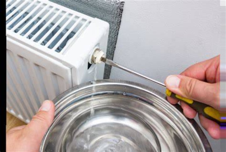 person bleeding radiator screwdriver