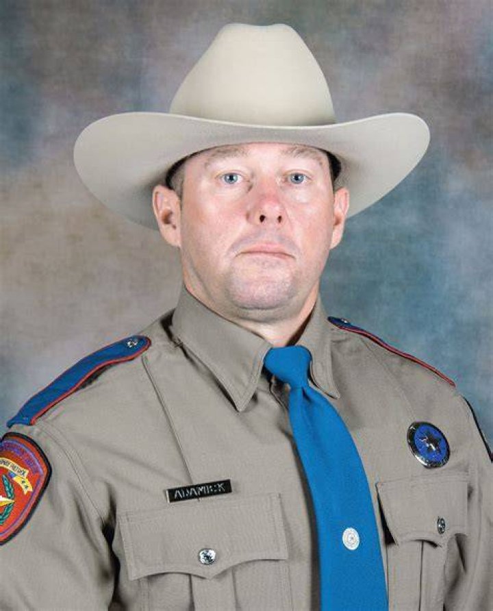 PHOTO: A DPS trooper looks at a school bus crash in Bastrop County, Texas, March 22, 2024.