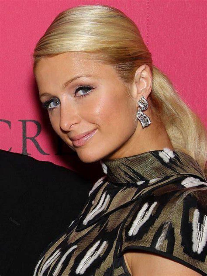 Photo shared by Paris Hilton on Instagram January 16 in a 1st birthday tribute to her son Phoenix, where she is carrying him, behind them a poster of Marilyn Monroe