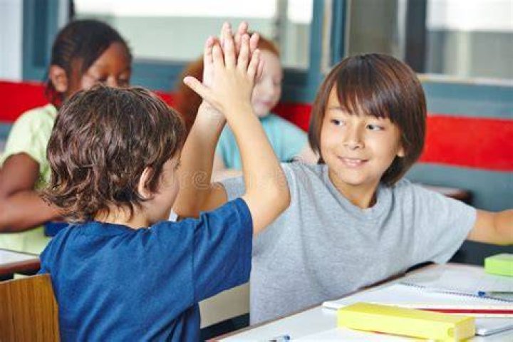 Two students high five during a seminary class in Salt Lake City.