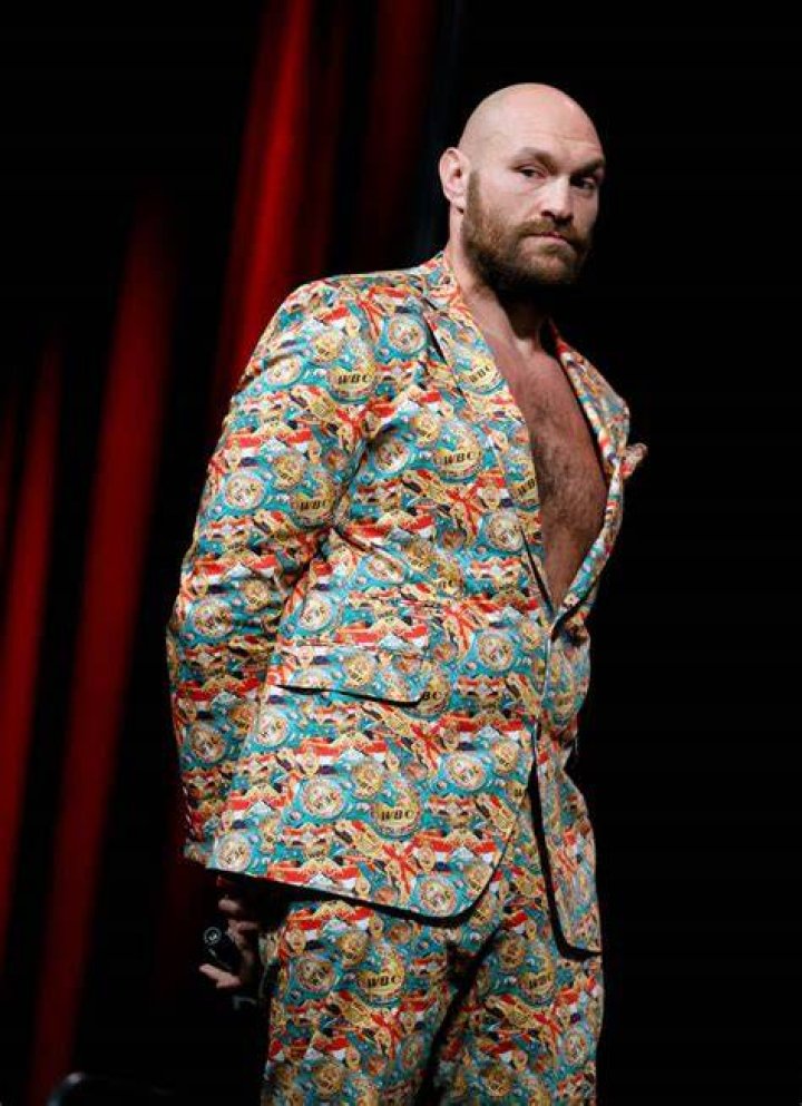 tyson fury in colourful suit on stage 