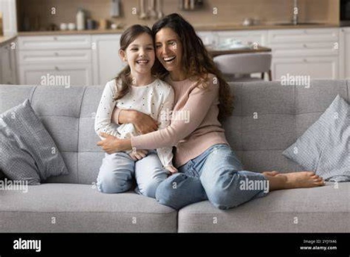 woman cuddling daughter 